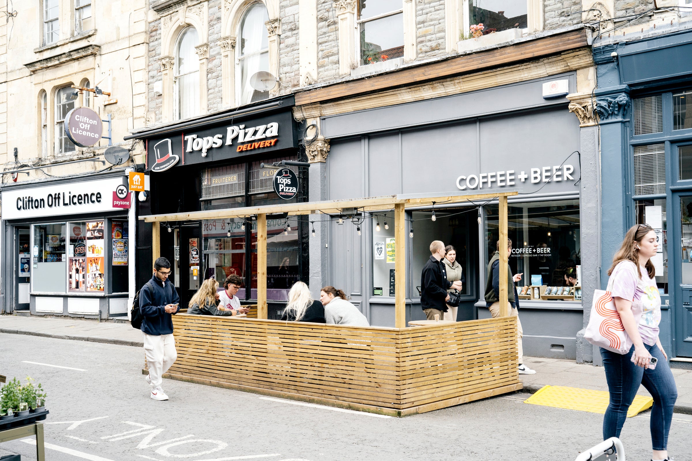 The Coffee + Beer shopfront on Cotham Hill, with people on the deck outside